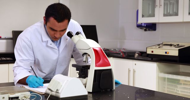 Scientist Analyzing Data in Laboratory with Microscope - Download Free Stock Images Pikwizard.com