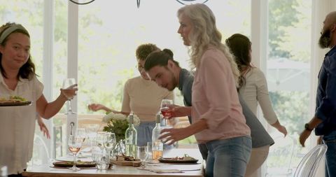 Family Enthusiastically Preparing Table for Wedding Celebration