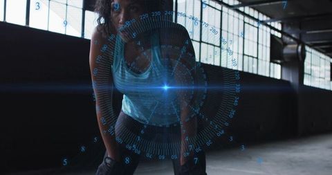 Athlete catching breath after intense workout under futuristic hud, backlit industrial gym