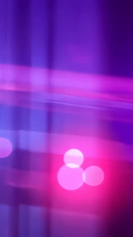 Vertical looping neon bokeh orbs pulsing and drifting in magenta violet glow