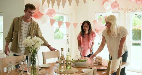 Friends Preparing for a Home Celebration with Decorations
