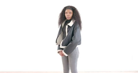 Confident Woman Standing in Stylish Jacket Against White Background - Download Free Stock Images Pikwizard.com