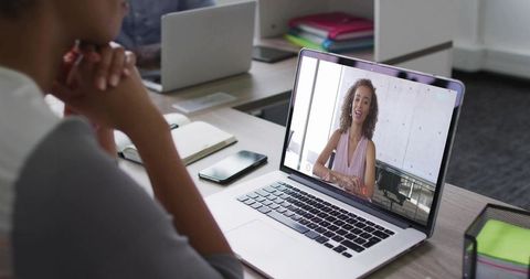 Virtual Meeting with Woman on Laptop Screen, Office Setting