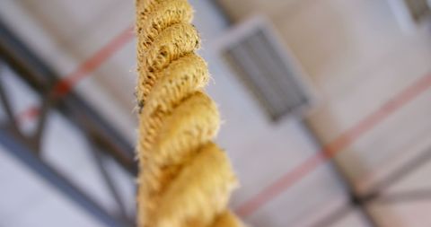 Close-up of textured exercise rope hanging in gym