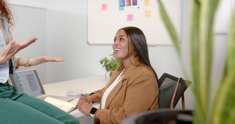 Colleagues collaborating on design project in office meeting