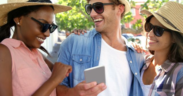 Happy Friends Laughing and Looking at Smartphone Outdoors - Download Free Stock Images Pikwizard.com