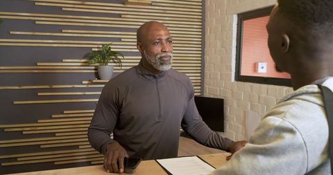 Senior mentor engaging with young professional at workplace