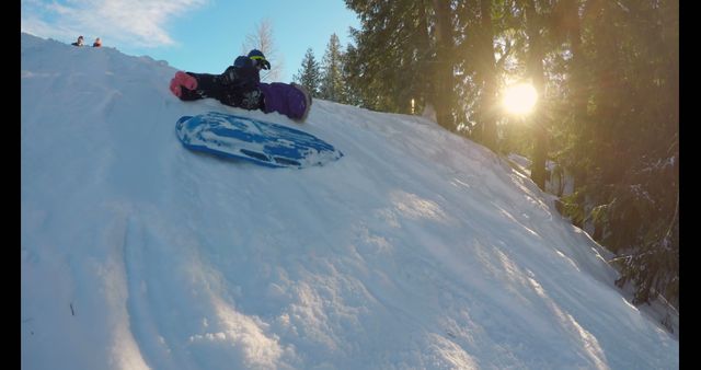 Children Sledding Down Snowy Hill on a Bright Winter Day - Download Free Stock Images Pikwizard.com