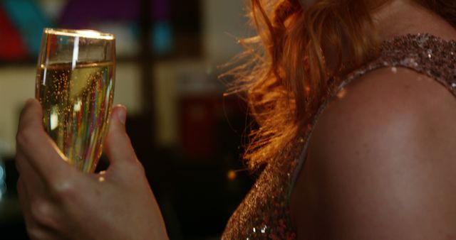 Beautiful woman drinking champagne in bar
