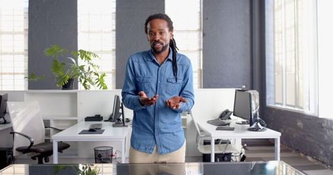 Confident Businessman Speaking in Modern Office Environment