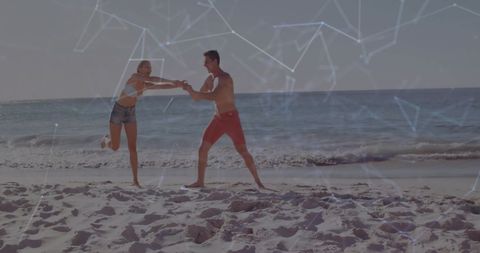 Couple Playing on Beach Overlaid with Digital Connection Networks