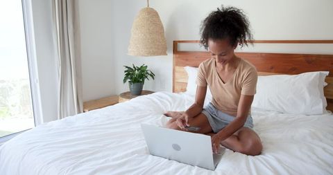 Woman Enjoying Modern Technology in Relaxed Bedroom Environment