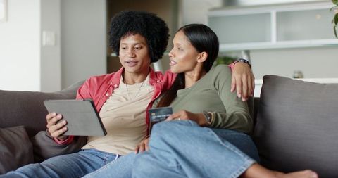 Diverse Couple Online Shopping with Tablet at Home