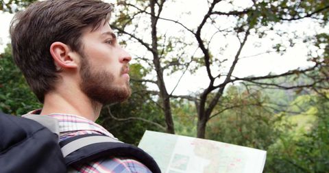 Young Explorer Planning Route with Map in Scenic Outdoors - Download Free Stock Images Pikwizard.com