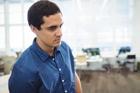 Professional Man Contemplating in Modern Office Environment