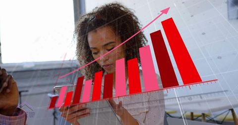 Businesswoman using tablet showing rising red bar chart overlay for analytics growth strategy