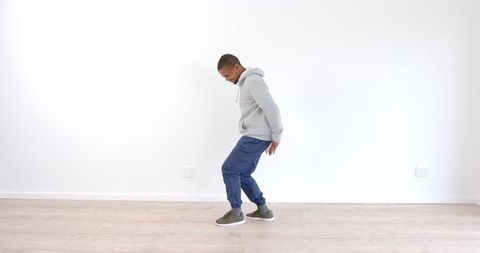 Energetic Dance by Man in Casual Attire on Wooden Floor - Download Free Stock Images Pikwizard.com