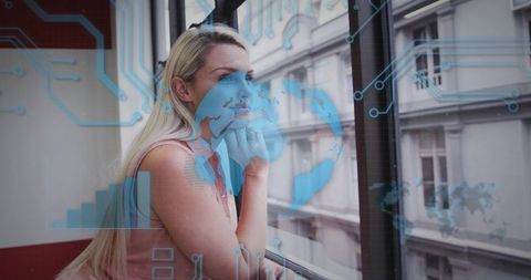 Contemplative Businesswoman Overlooking Urban View with Futuristic Data Overlay