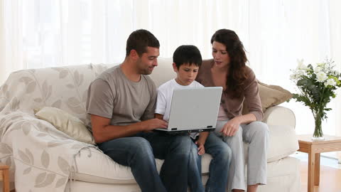 Family Spending Quality Time on Laptop at Home
