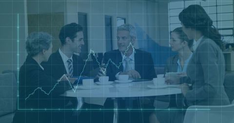 Business Meeting: Professionals Discuss Strategy Amid Stock Chart Atmosphere