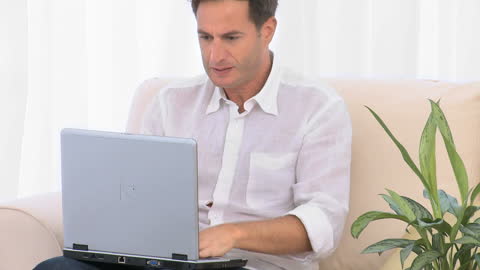 Stressed Man Working on Laptop from Home