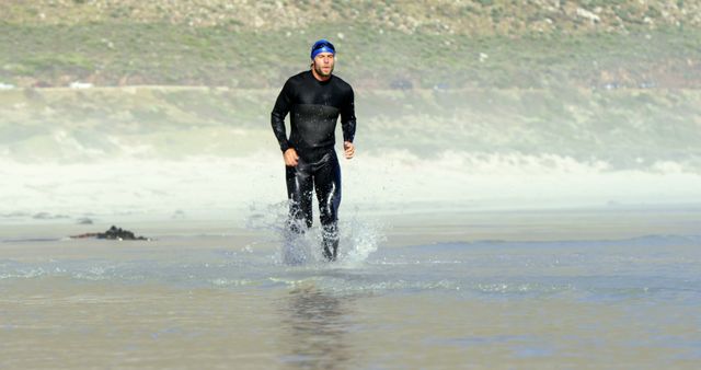 Triathlete Jogging on Beach during Sunny Day - Download Free Stock Images Pikwizard.com