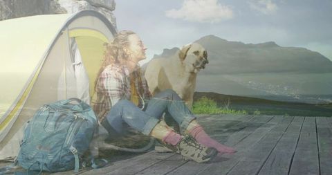 Female Camper Enjoying Mountain View with Hiking Dog by Tent