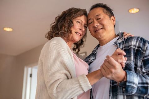 Senior Couple Dancing at Home Embracing Intimacy and Joy