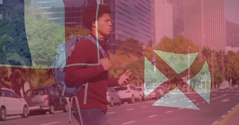 Young Urban Commuter Walking through City Crosswalk with Smartphone