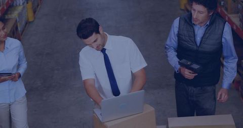 Warehouse Team Collaborating on Logistics with Digital Tools