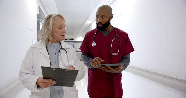 Medical Professionals Discussing Patient Information in Hospital Corridor - Download Free Stock Images Pikwizard.com