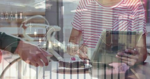 Businesswoman exploring financial data over coffee