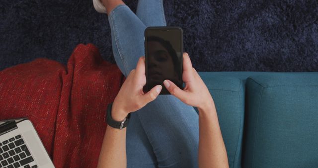 Above View of Person Using Smartphone on Blue Sofa - Download Free Stock Images Pikwizard.com