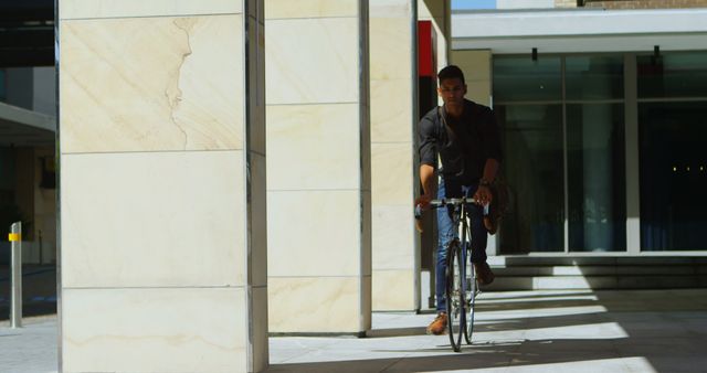 Urban Commuter Biking on Sunny Day Near Modern Buildings - Download Free Stock Images Pikwizard.com