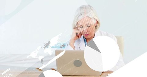 Senior female scientist analyzing data on laptop