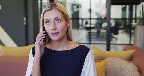Businesswoman Discussing on Smartphone in Casual Office Space - Download Free Stock Images Pikwizard.com