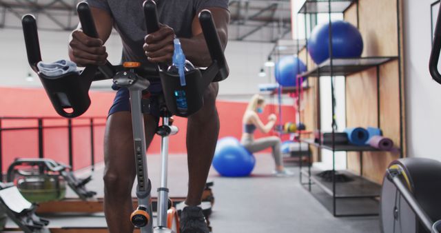 Athlete using exercise bike in modern gym, focusing on fitness goals - Download Free Stock Images Pikwizard.com