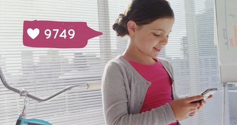 Girl enjoying social media while leaning on bicycle