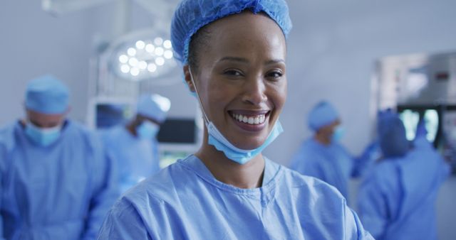 Smiling Surgeon in Operating Room with Team in Background - Download Free Stock Images Pikwizard.com