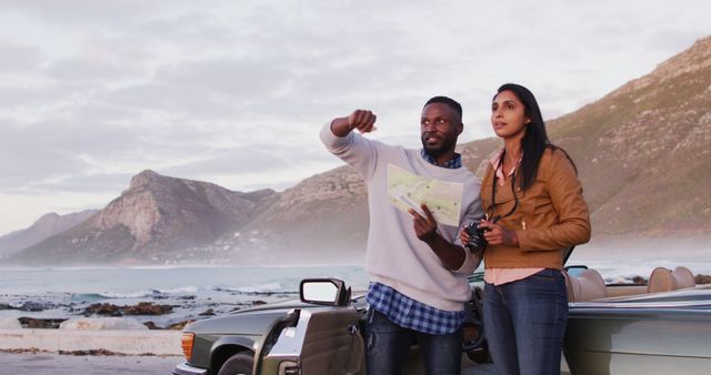 Black couple consults a map by their convertible during a road trip adventure. - Download Free Stock Photos Pikwizard.com
