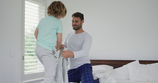 Father and son bonding while making bed in the morning - Download Free Stock Images Pikwizard.com