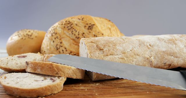 Freshly Baked Bread Loaves with Sliced Baguette on Wooden Board - Download Free Stock Images Pikwizard.com