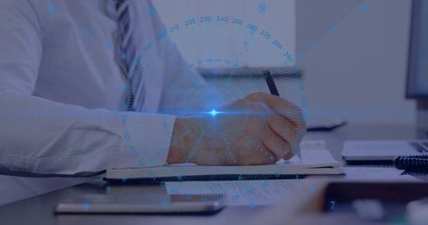 Business professional writing notes with holographic HUD overlay on office desk