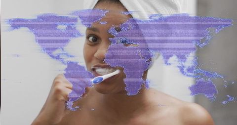 Brushing teeth with digital world overlay, woman in towel practicing morning self-care