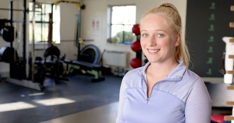 Smiling Woman in Gym During Rehabilitation Session