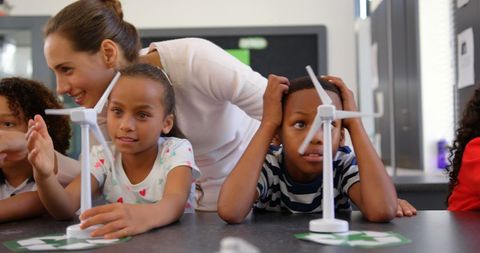 Teacher Engaging Children with Windmill Models in Classroom