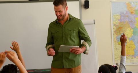 Engaging school teacher with digital tablet in diverse classroom