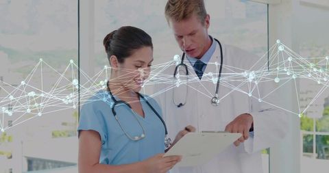 Doctor and Nurse Collaborate with Technology in Medical Office