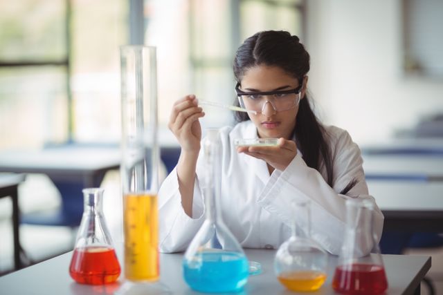 Attentive schoolgirl experimenting in laboratory at school