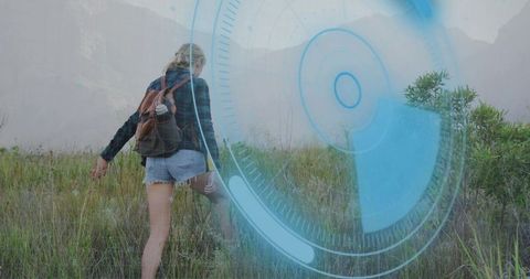 Hiker Exploring Mountain Valley with Futuristic Overlay